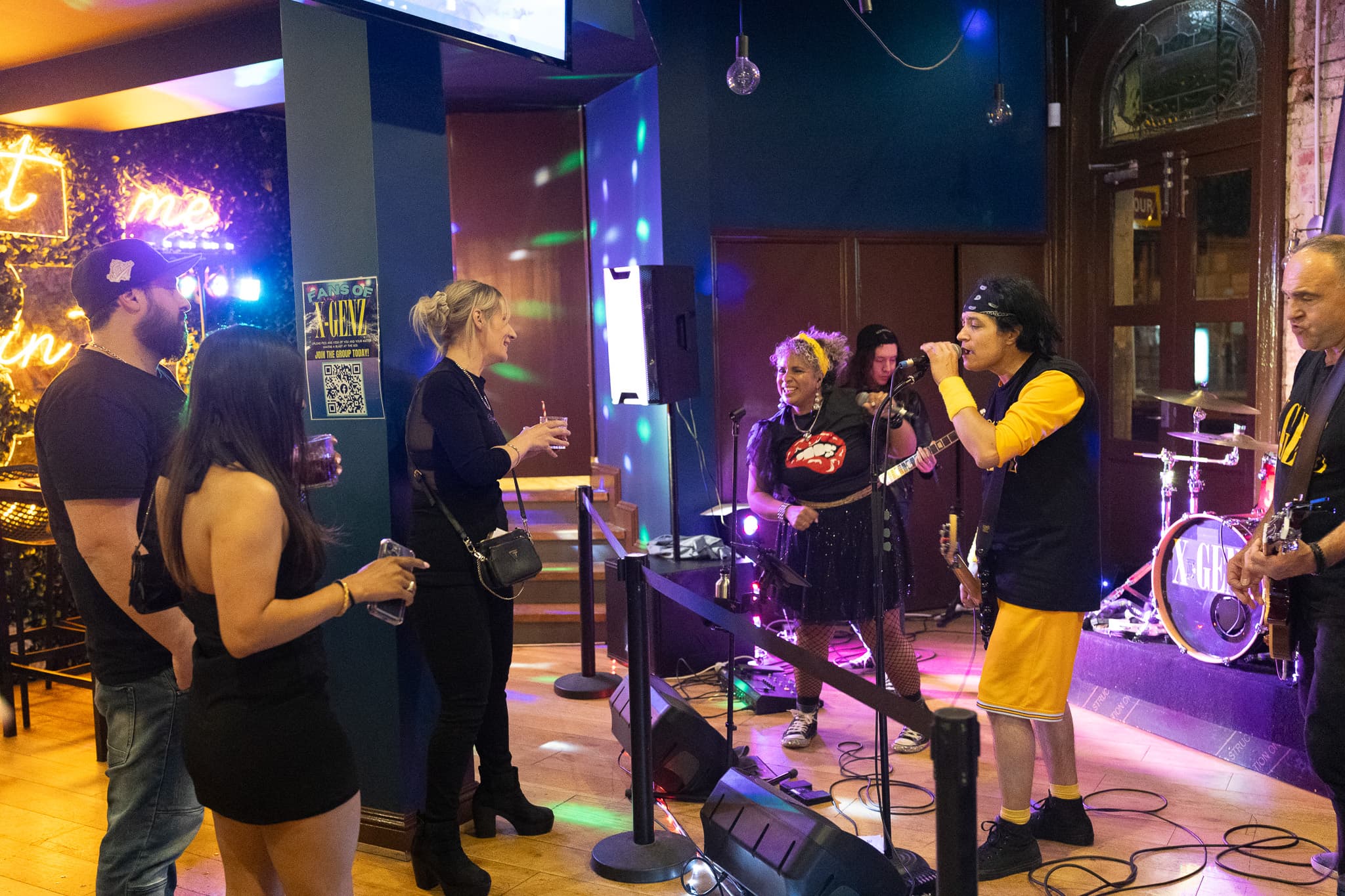 Cornerstone Pub vibrant outdoor space with guests enjoying live sports on big screens, socializing, and dining in Port Melbourne